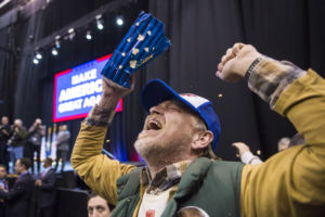 Jake Buird throws popcorn and shouts in celebration after seeing Trump up close. (Photo by Jabin Botsford/The Washington Post)